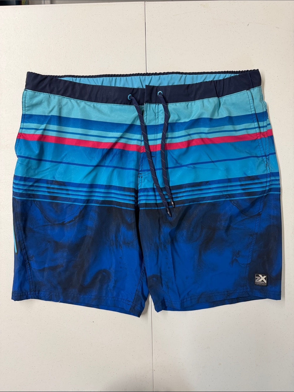 ZeroXposur Blue & Aqua Striped Swim Shorts with Red Accent